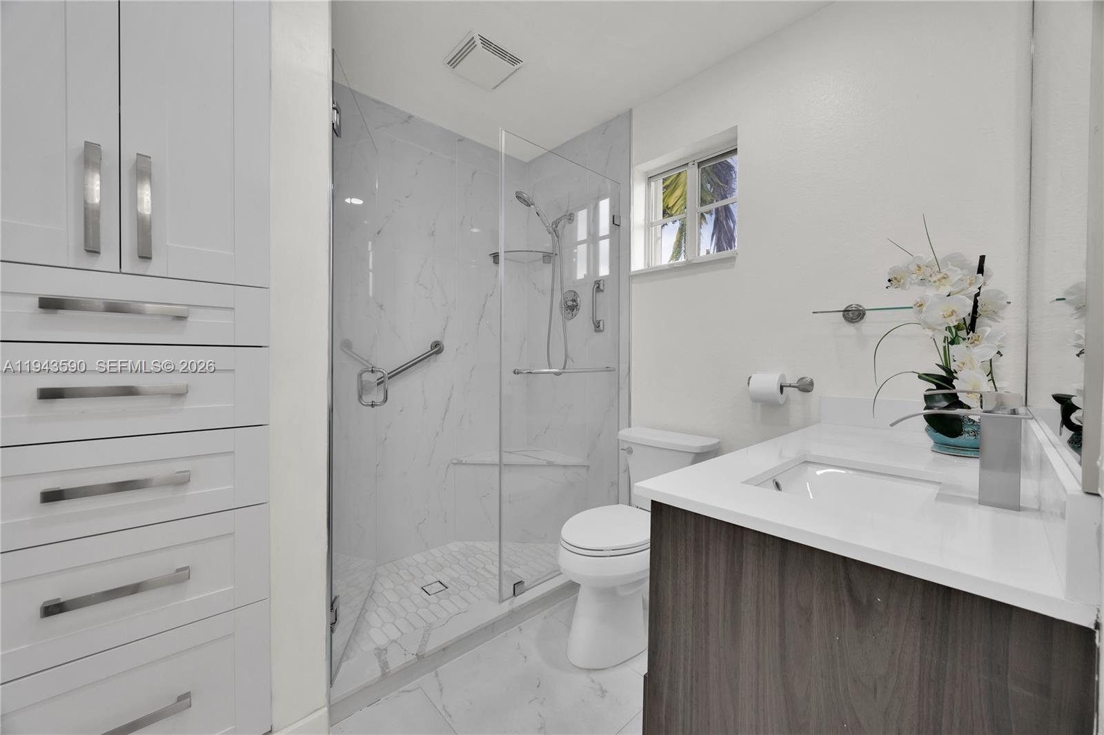 7773 Southwest 94th Lane Miami, FL 33156 - Photo 18 of 50 a bathroom with a sink a toilet and shower