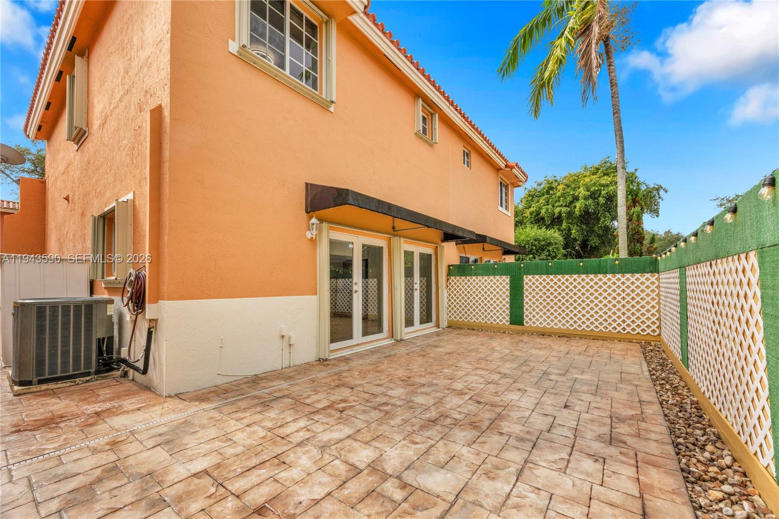 7773 Southwest 94th Lane Miami, FL 33156 - Photo 21 of 50 a view of a white house with a yard