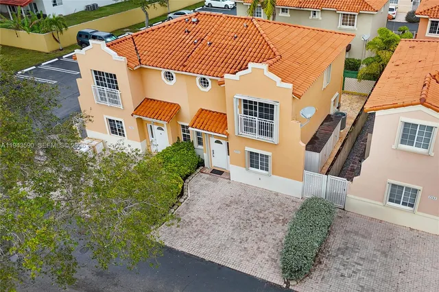 an aerial view of house with a yard