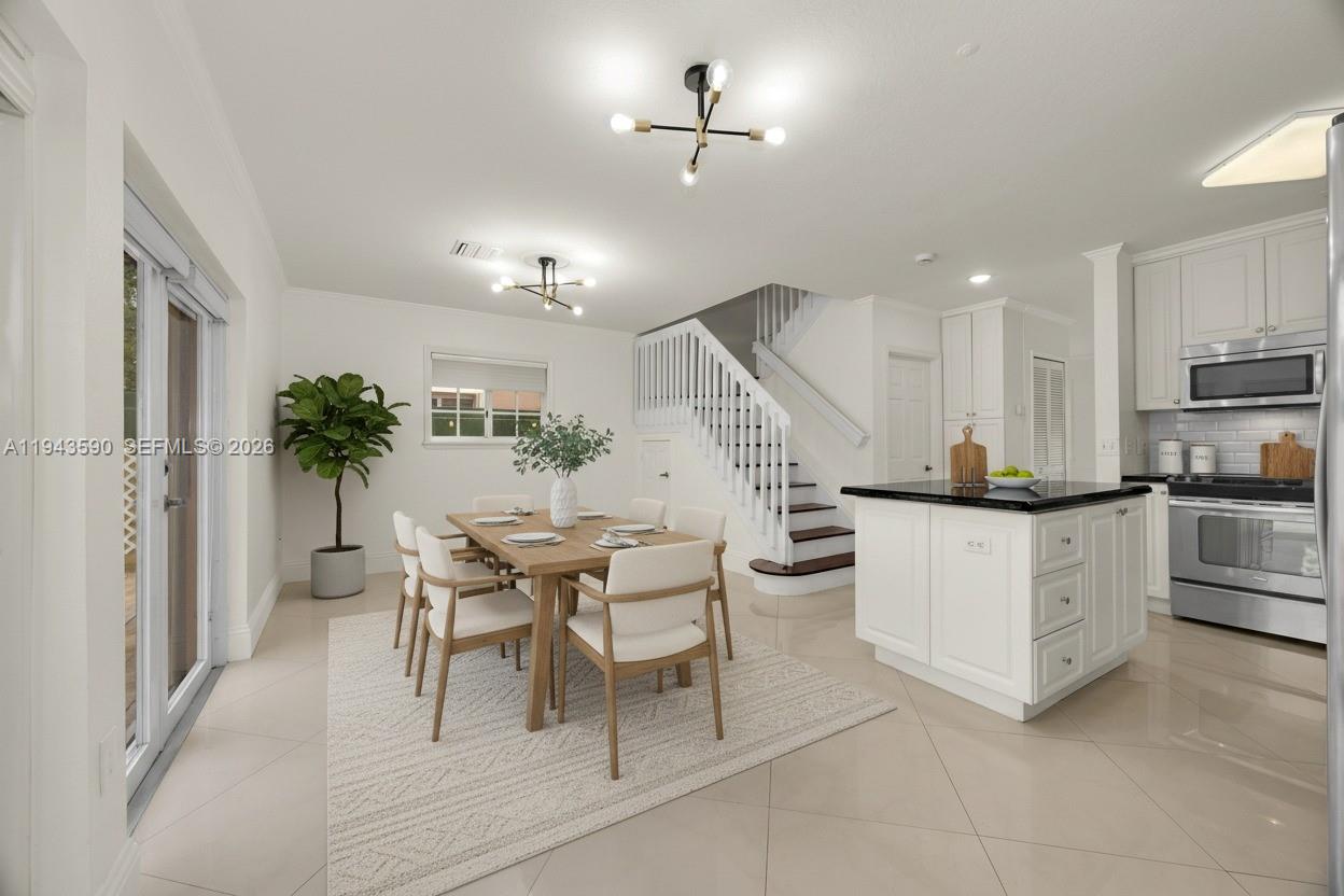 7773 Southwest 94th Lane Miami, FL 33156 - Photo 5 of 50 a open kitchen with stainless steel appliances kitchen island granite countertop a table chairs and a refrigerator