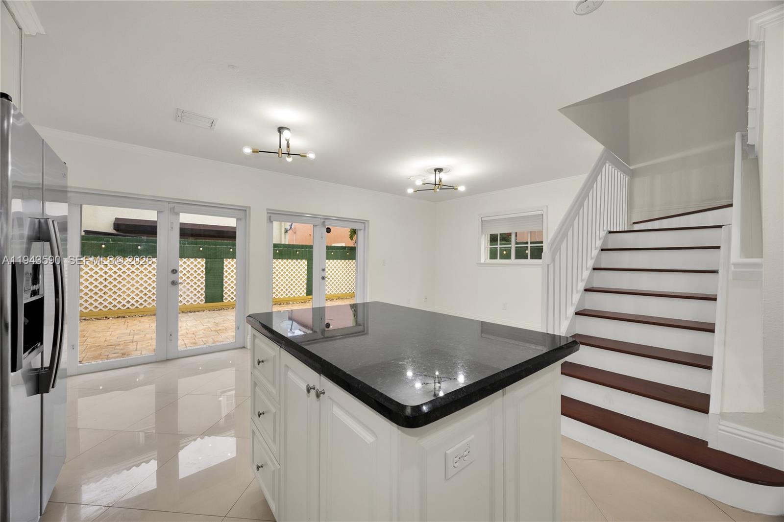 7773 Southwest 94th Lane Miami, FL 33156 - Photo 8 of 50 a kitchen with a sink a counter top space and windows