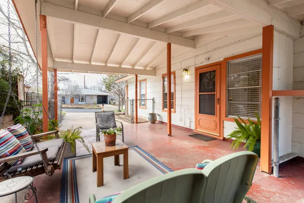 a living room with furniture a dining table and a potted plant