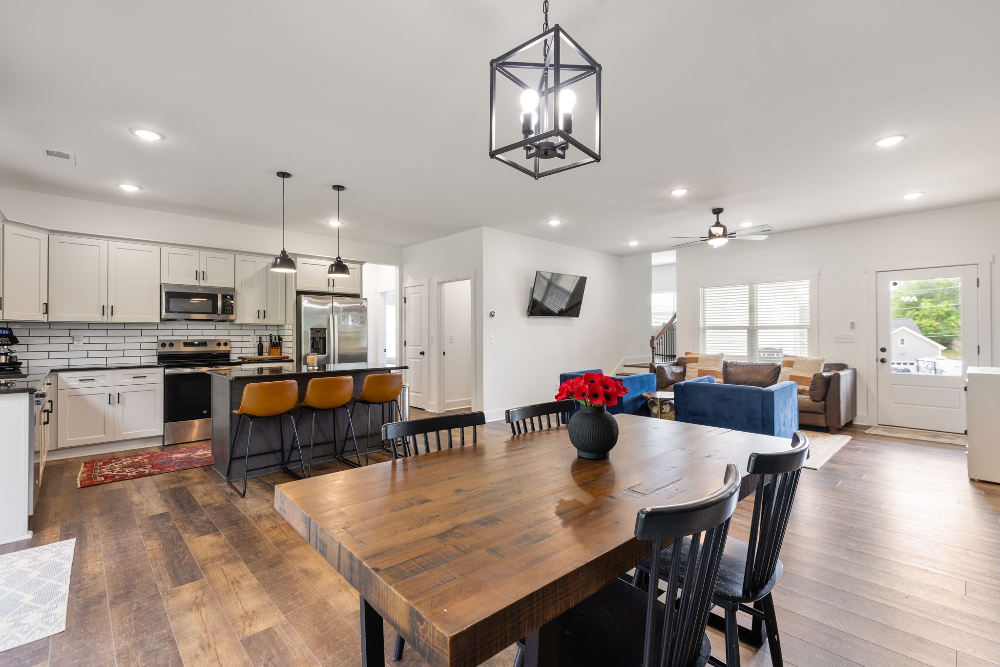 1578 Angus Way Greenbrier, TN 37073 - Photo 13 of 45 a kitchen with stainless steel appliances kitchen island granite countertop a dining table chairs and white cabinets