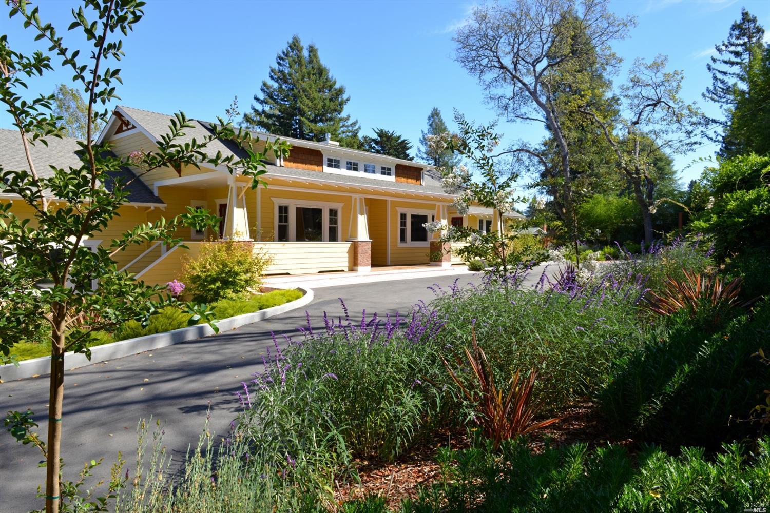 a front view of a house with yard and green space
