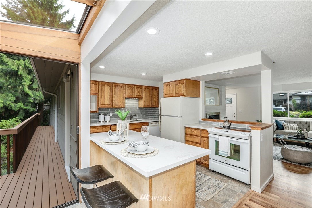 24106 4th Place West Bothell, WA 98021 - Photo 11 of 36 a kitchen that has a stove and white cabinets