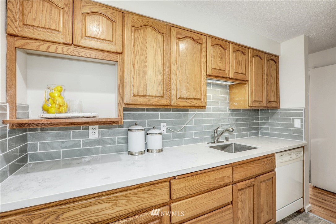 24106 4th Place West Bothell, WA 98021 - Photo 13 of 36 a kitchen with a sink and cabinets