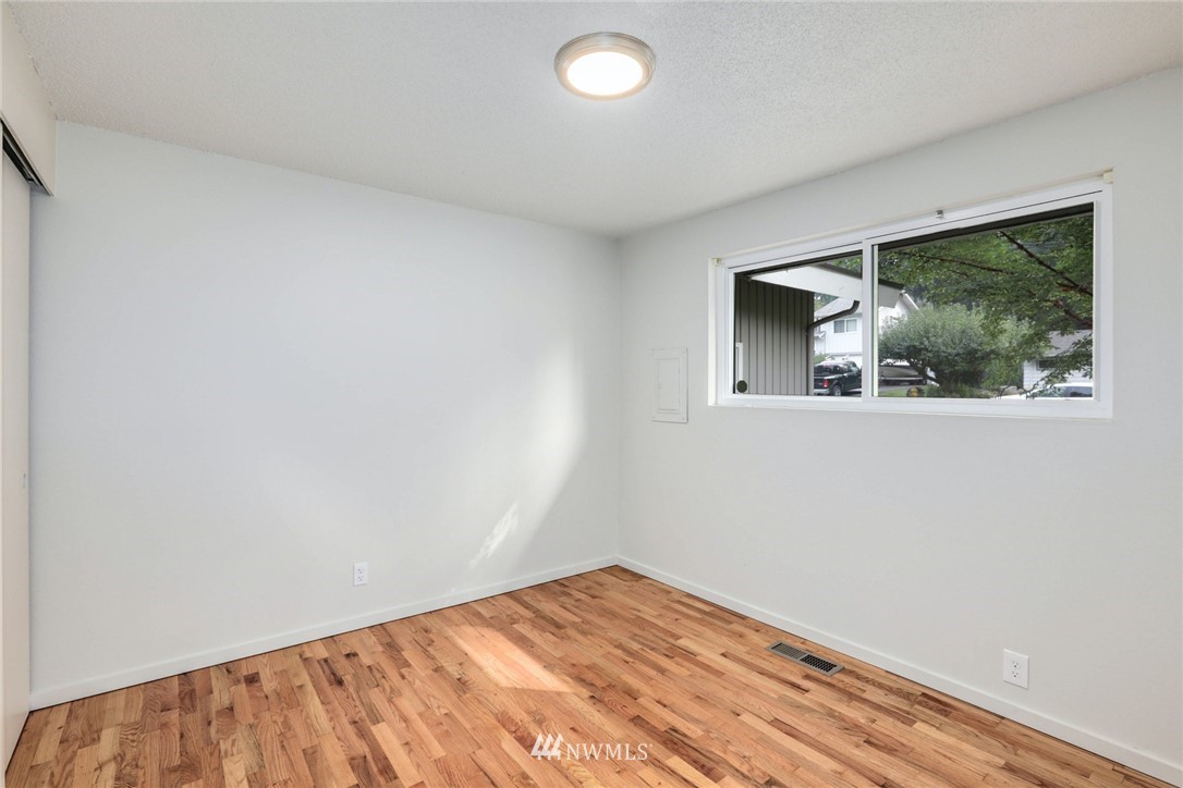 24106 4th Place West Bothell, WA 98021 - Photo 17 of 36 an empty room with wooden floor and windows