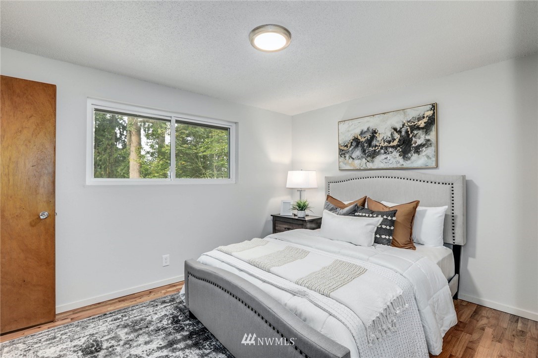 24106 4th Place West Bothell, WA 98021 - Photo 18 of 36 a bedroom with a bed and a painting on the wall