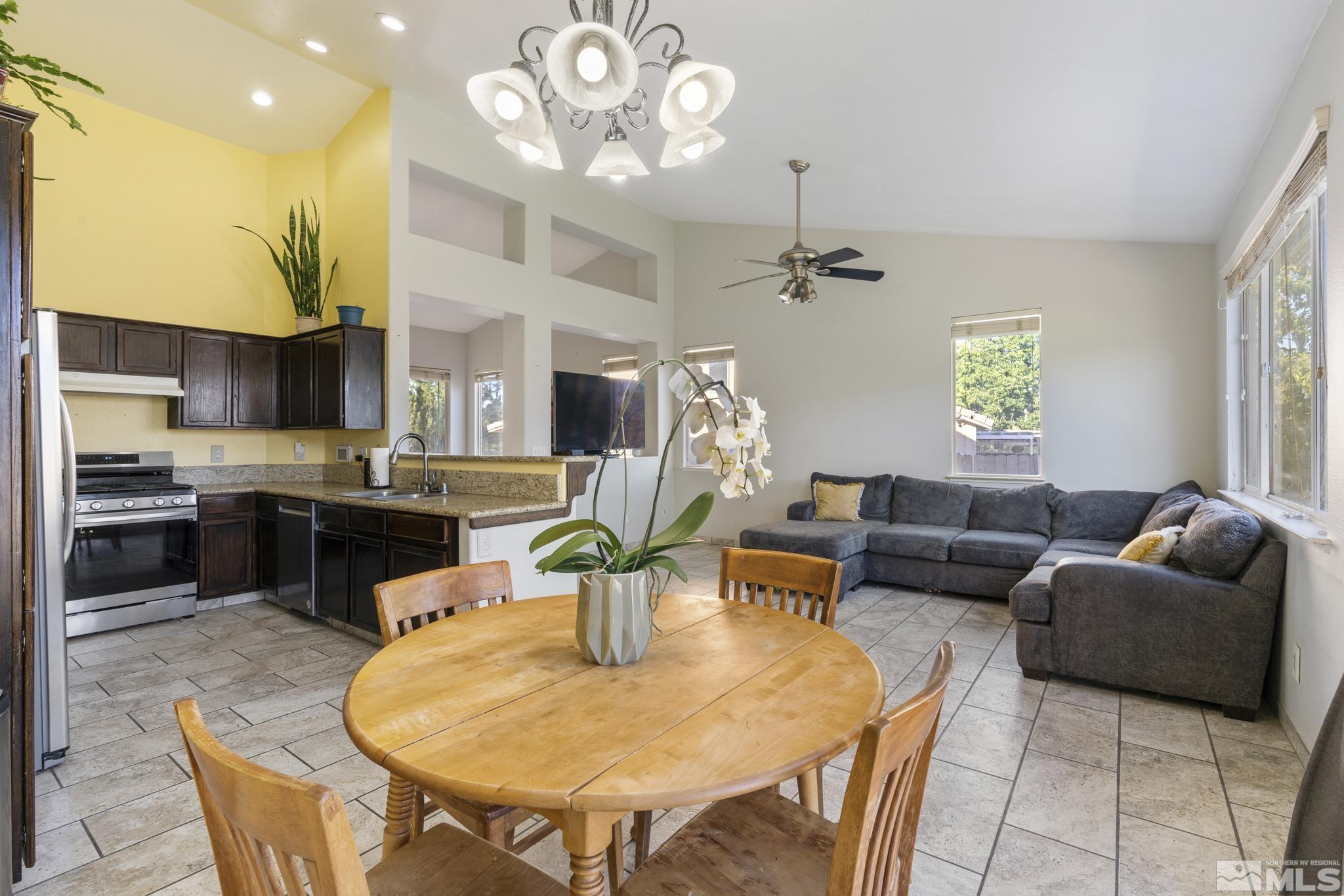 11760 Claim Stake Drive Reno, NV 89506 - Photo 11 of 22 a living room with fireplace furniture and a chandelier