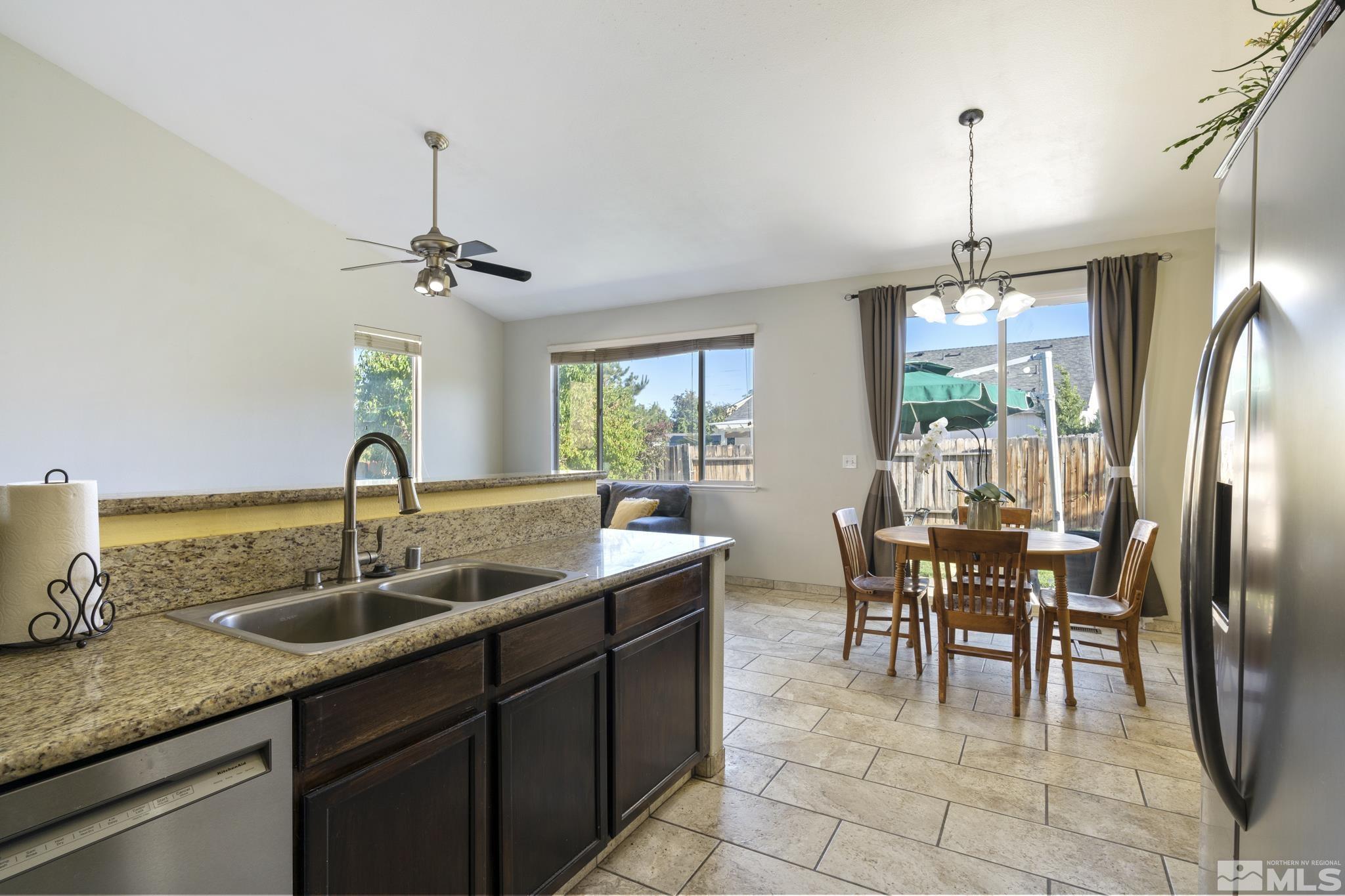 11760 Claim Stake Drive Reno, NV 89506 - Photo 12 of 22 a kitchen with sink cabinets and dining table