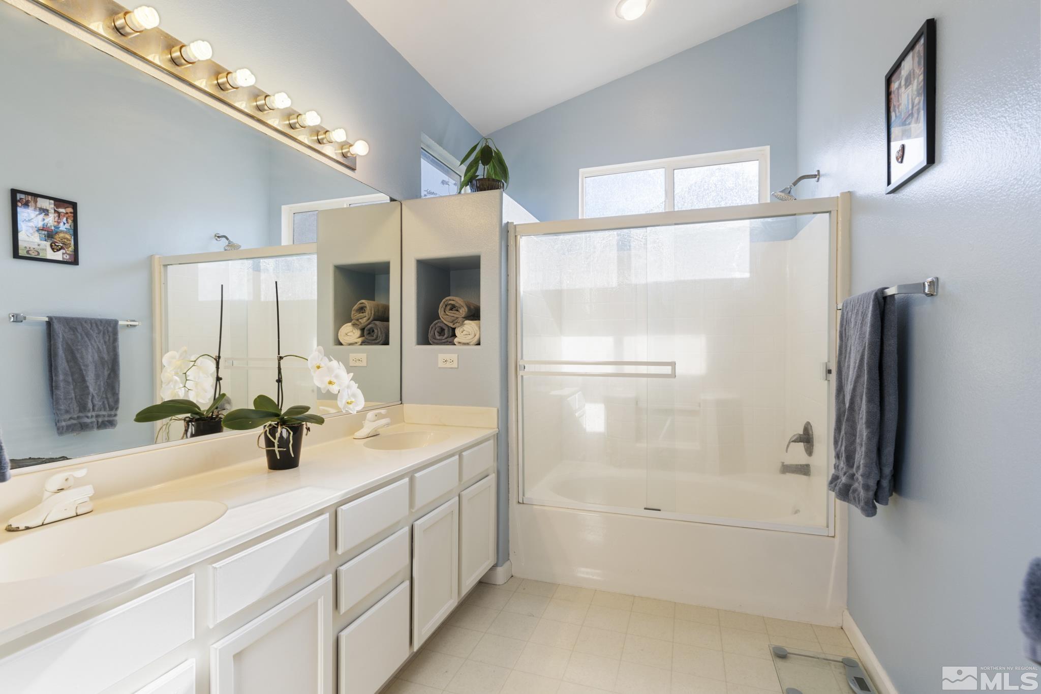 11760 Claim Stake Drive Reno, NV 89506 - Photo 14 of 22 a bathroom with a double vanity sink mirror and shower