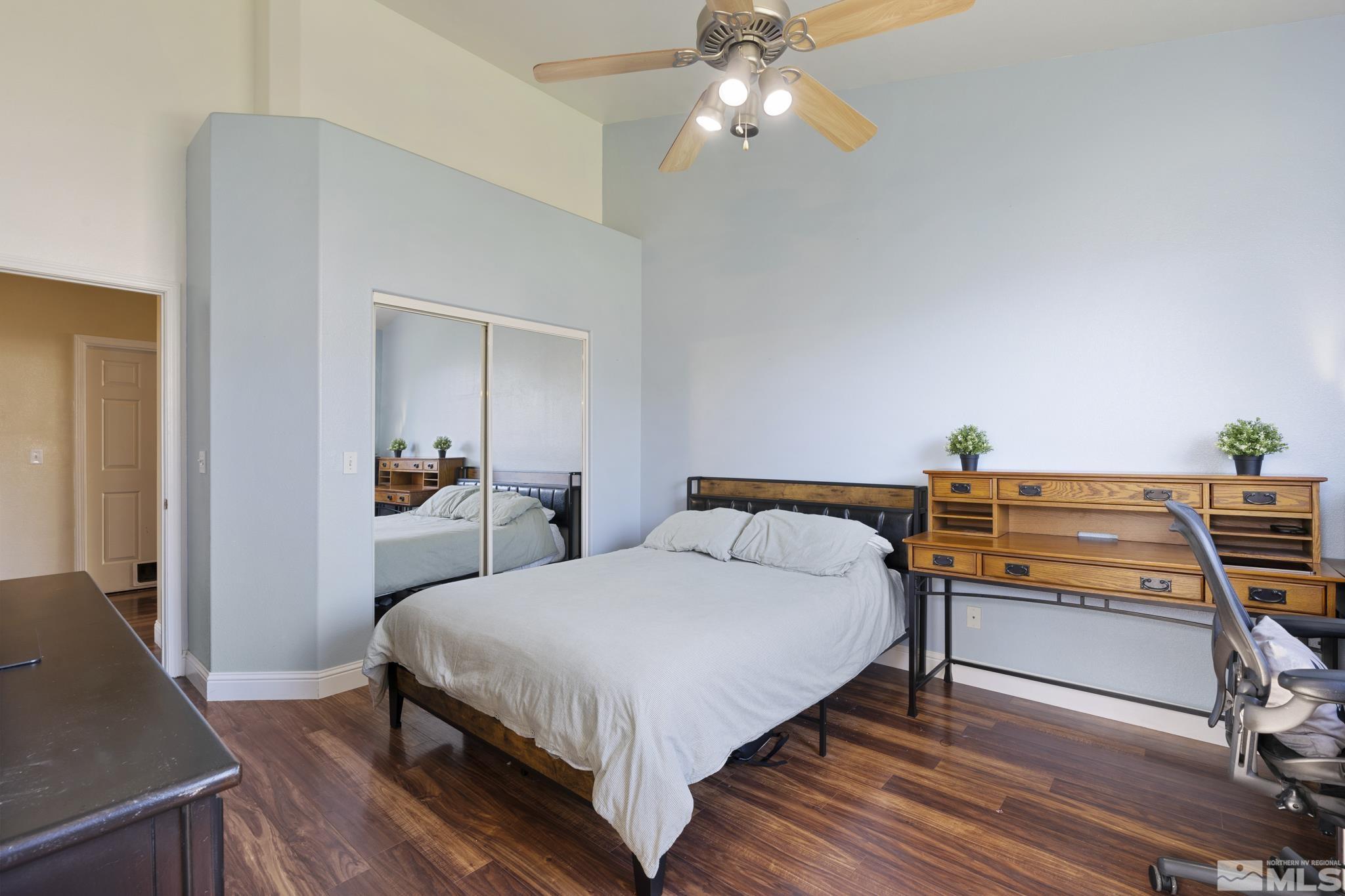 11760 Claim Stake Drive Reno, NV 89506 - Photo 15 of 22 a bedroom with a bed and a chandelier