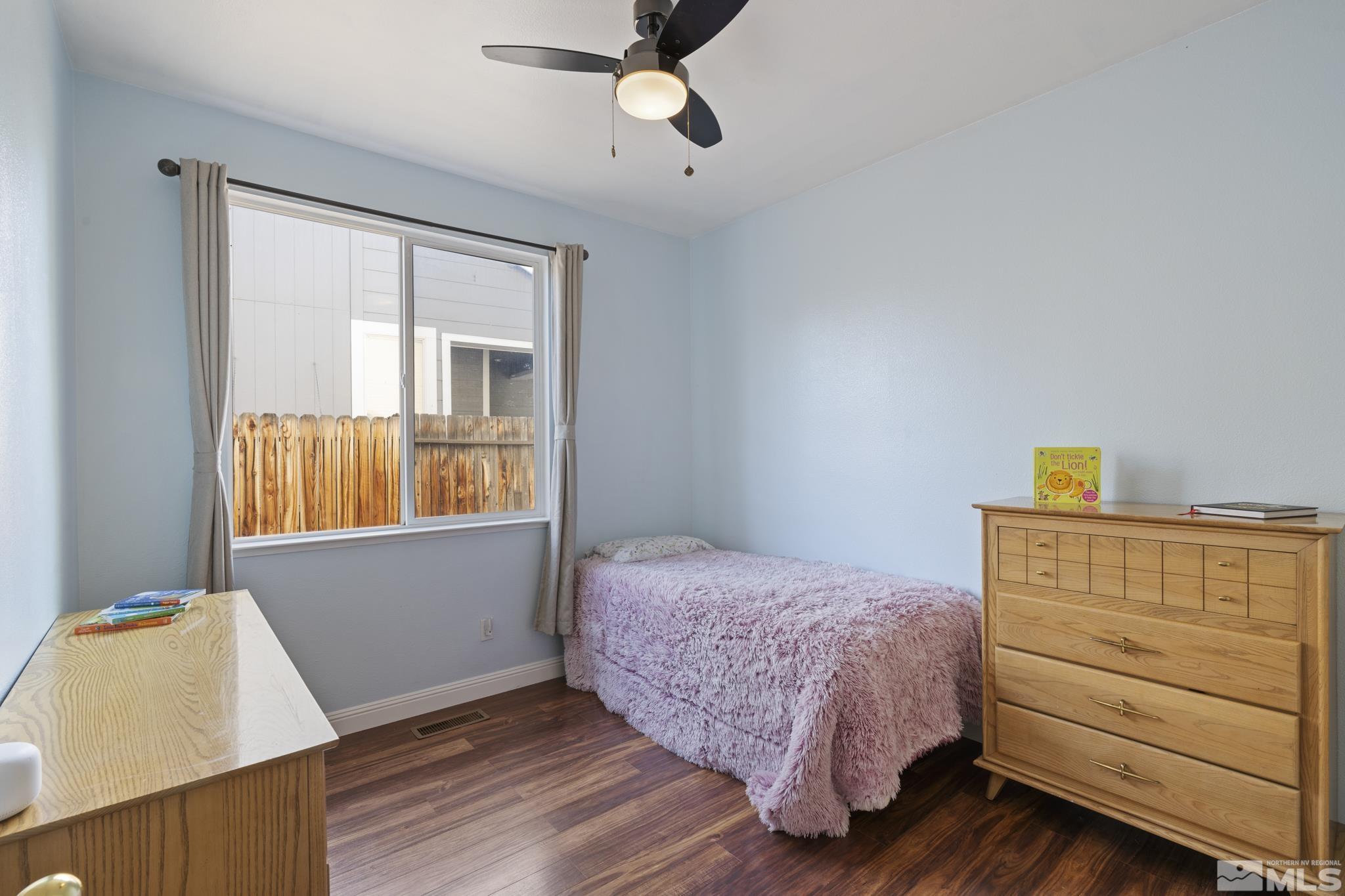 11760 Claim Stake Drive Reno, NV 89506 - Photo 18 of 22 a bedroom with a bed and wooden floor