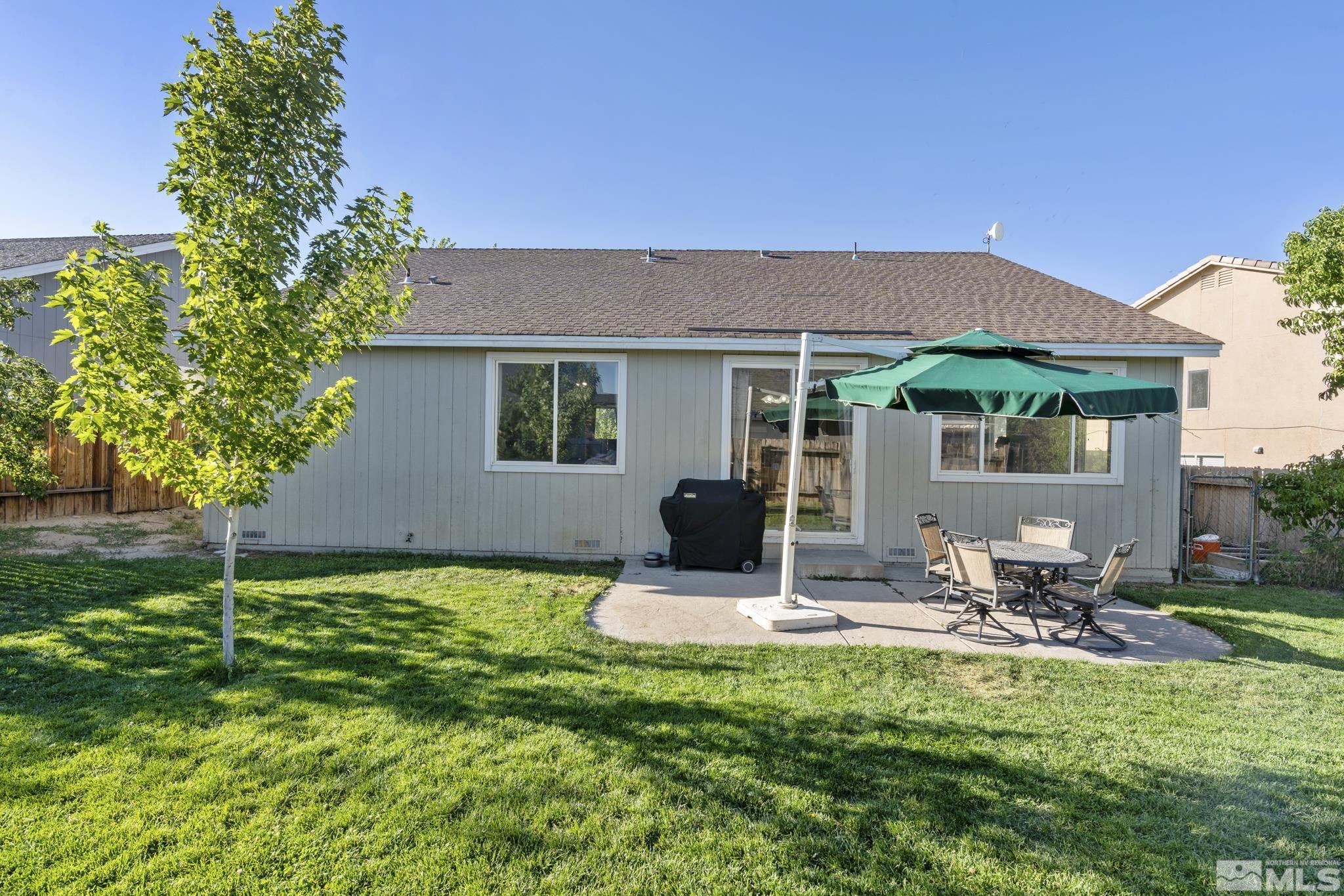 11760 Claim Stake Drive Reno, NV 89506 - Photo 21 of 22 a view of a patio with table and chairs under an umbrella