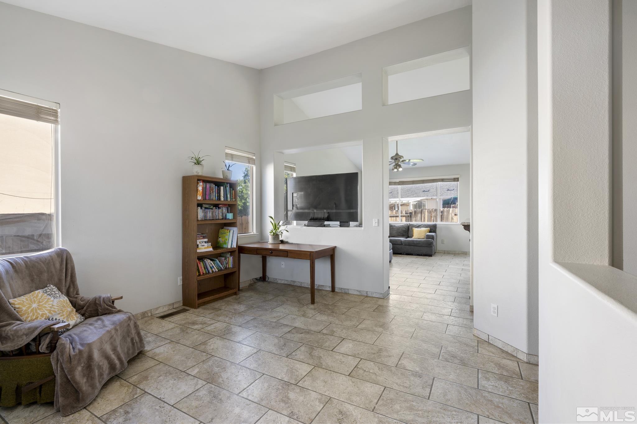 11760 Claim Stake Drive Reno, NV 89506 - Photo 3 of 22 a living room with furniture and a flat screen tv