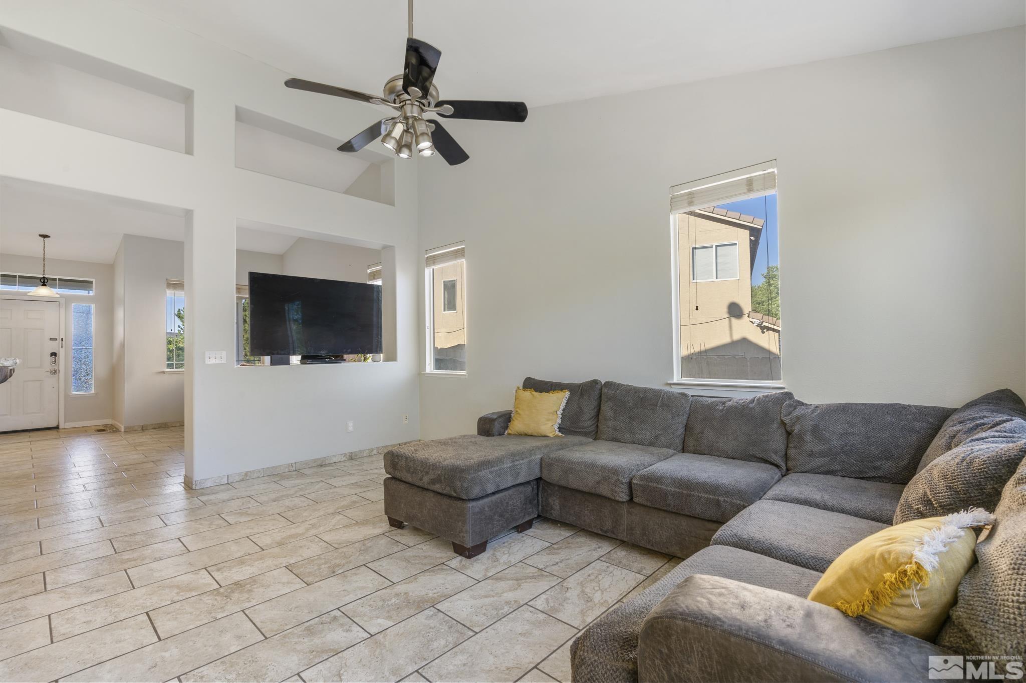 11760 Claim Stake Drive Reno, NV 89506 - Photo 5 of 22 a living room with furniture and a flat screen tv
