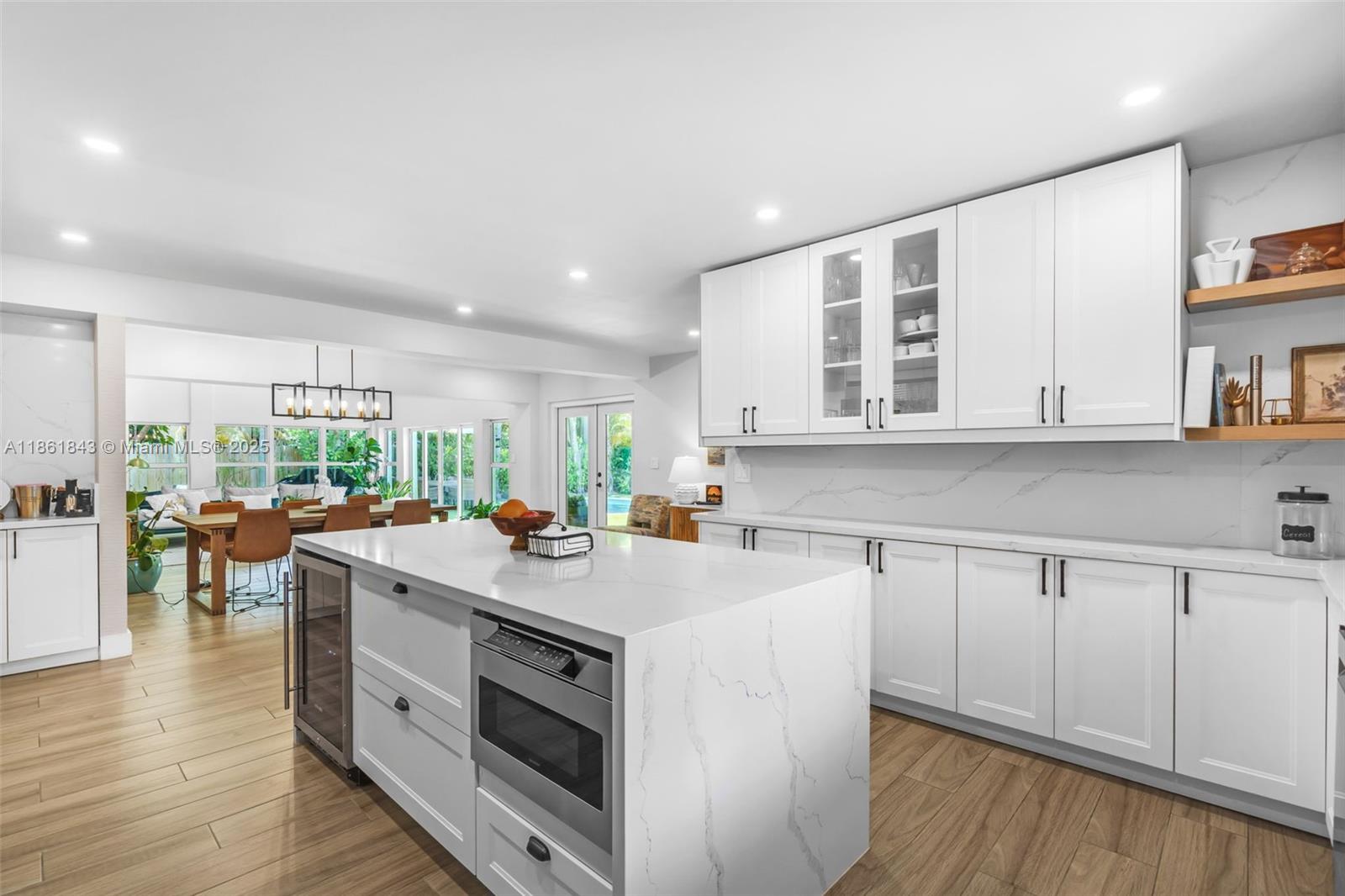653 Glenridge Road Key Biscayne, FL 33149 - Photo 16 of 47 a kitchen with a sink stove and cabinets