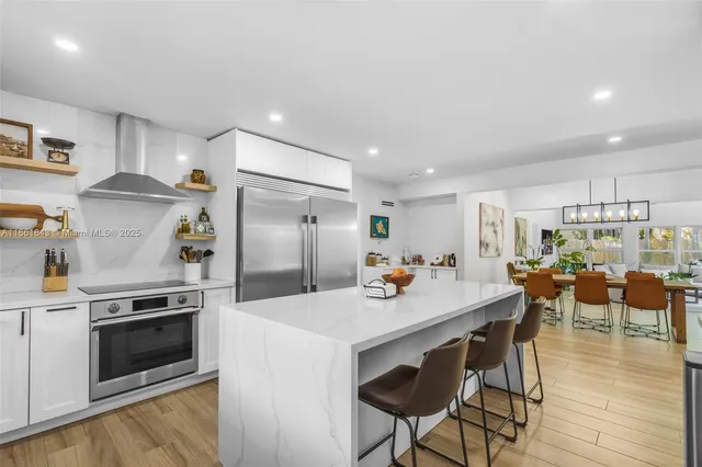 a kitchen with a sink a stove and cabinets