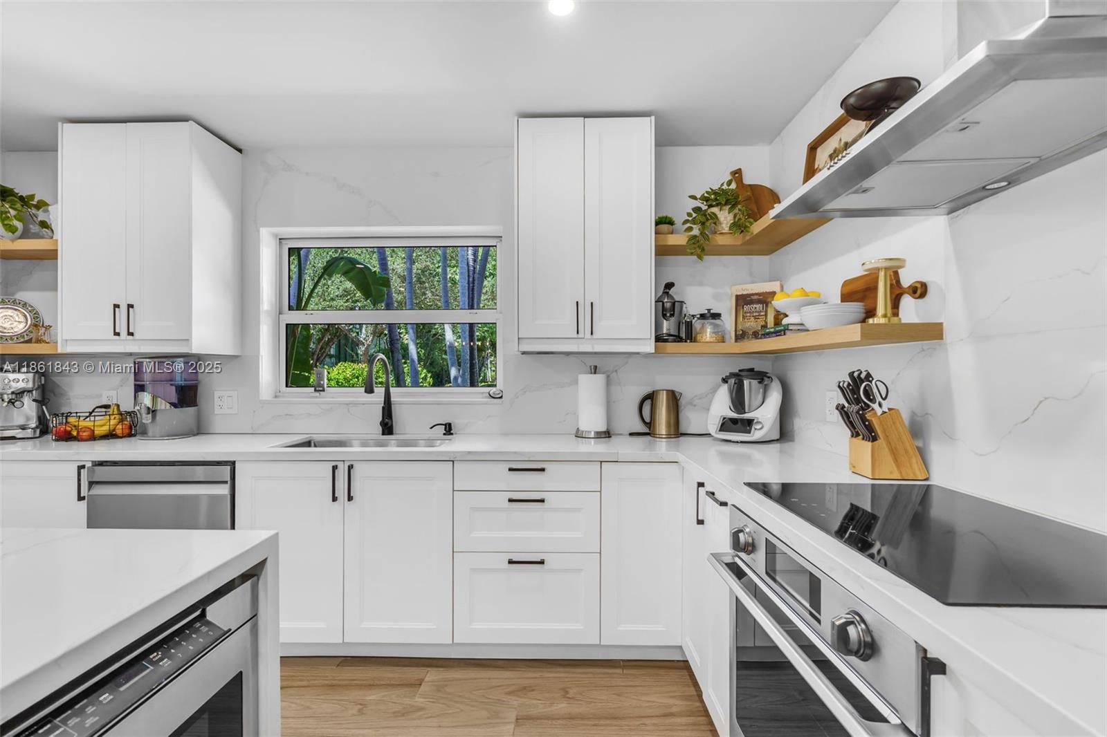653 Glenridge Road Key Biscayne, FL 33149 - Photo 18 of 47 a kitchen with a sink a stove and cabinets