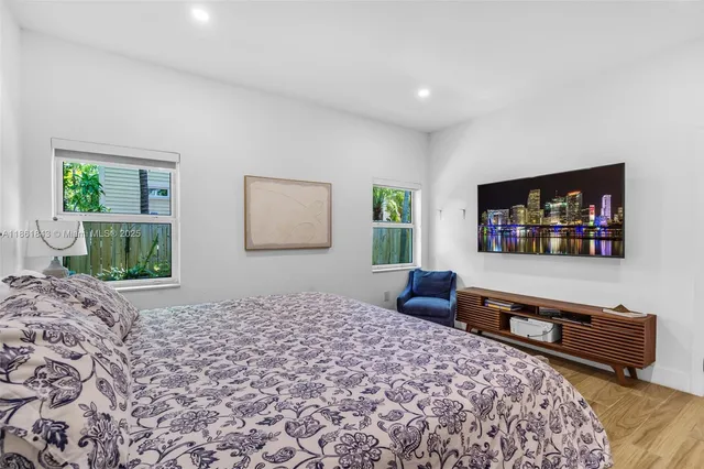 a bedroom with a bed and a dresser in it