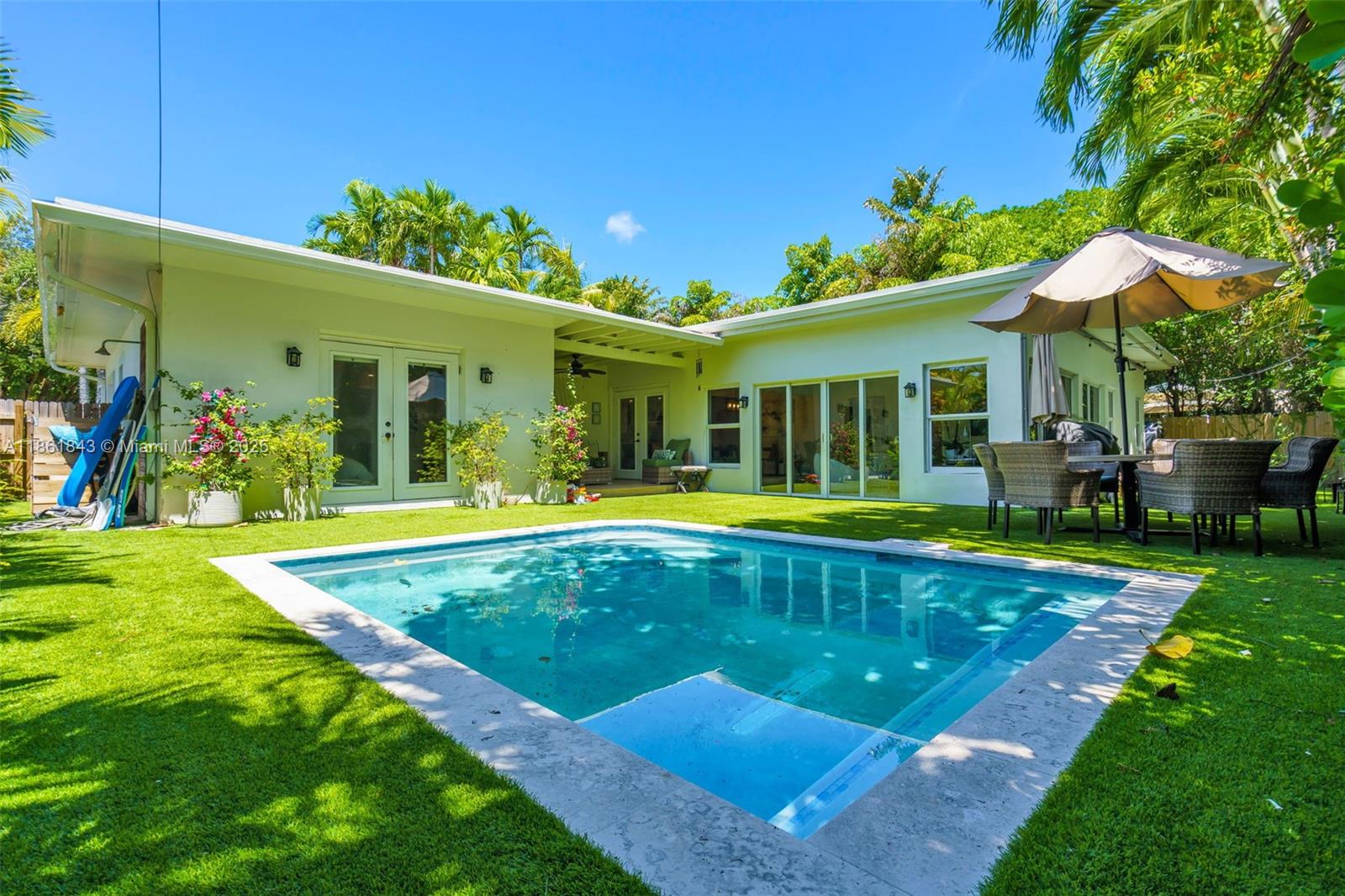653 Glenridge Road Key Biscayne, FL 33149 - Photo 2 of 47 a view of a house with swimming pool yard and patio