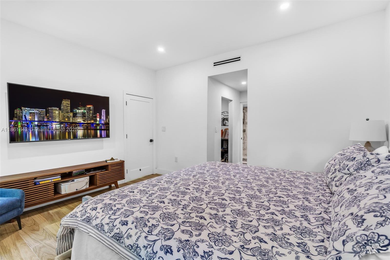 653 Glenridge Road Key Biscayne, FL 33149 - Photo 21 of 47 a bedroom with a bed and a dresser in it