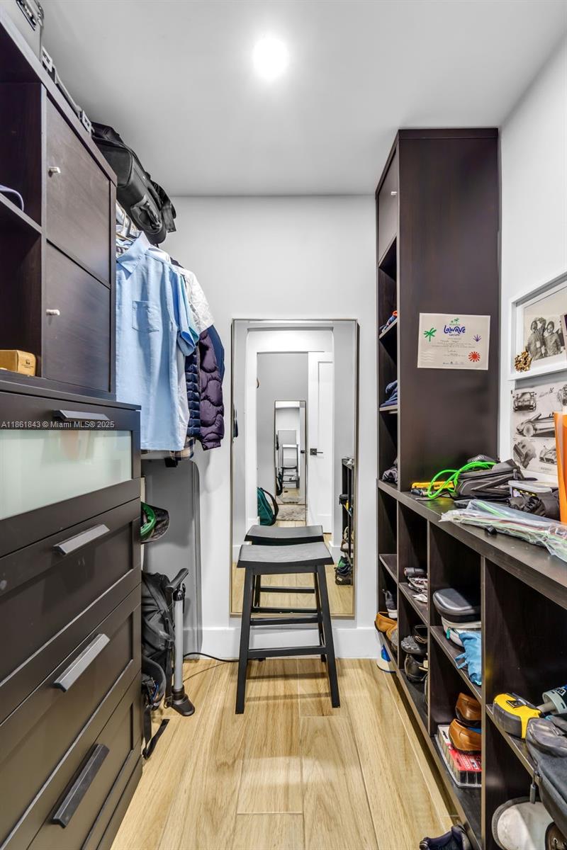 653 Glenridge Road Key Biscayne, FL 33149 - Photo 23 of 47 a hallway with a stove and a wooden floor