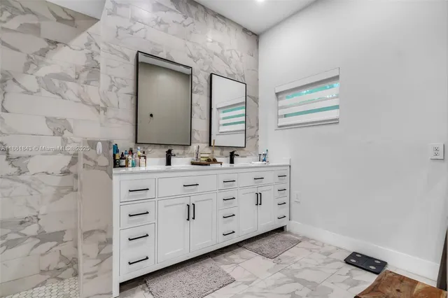 a bathroom with a shower sink and mirror