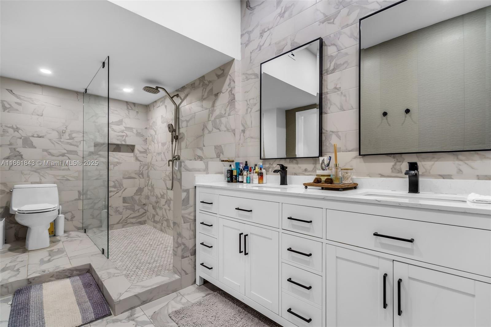 653 Glenridge Road Key Biscayne, FL 33149 - Photo 26 of 47 a bathroom with a shower sink and mirror