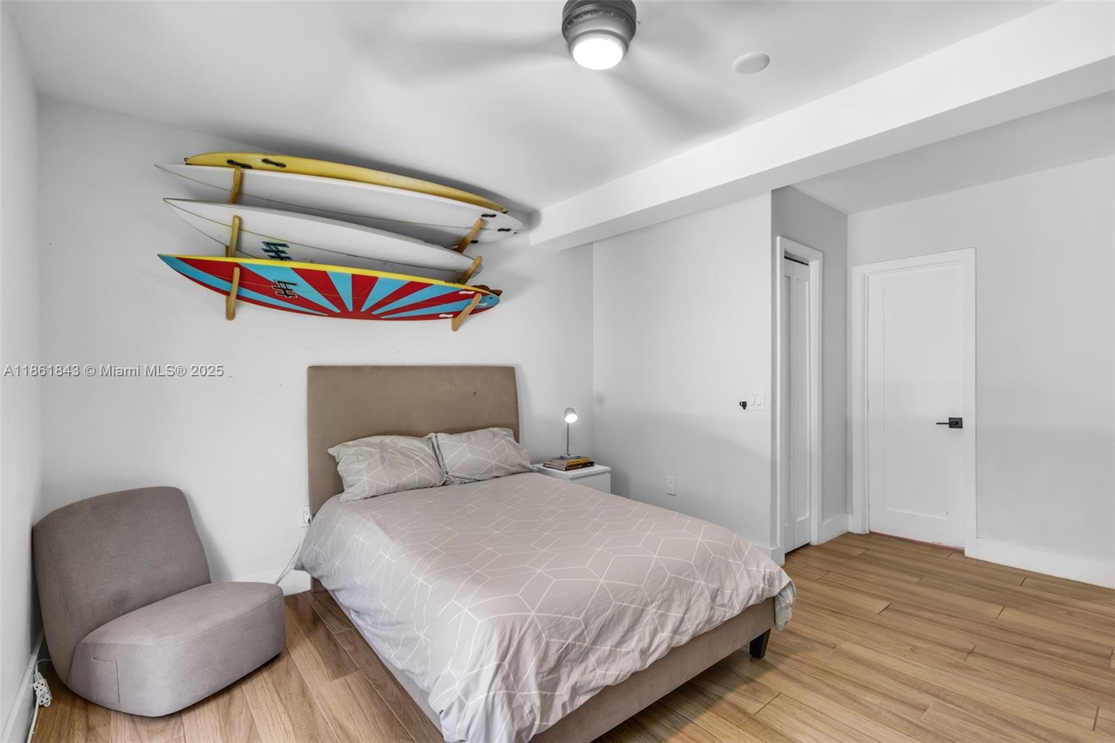 653 Glenridge Road Key Biscayne, FL 33149 - Photo 30 of 47 a bedroom with a bed and a chair