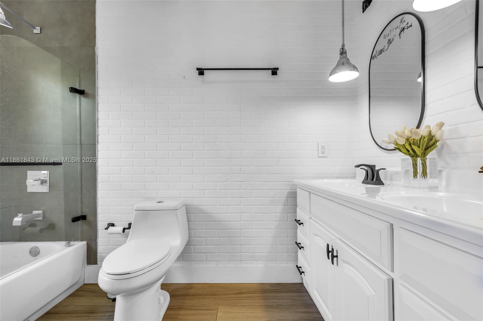 653 Glenridge Road Key Biscayne, FL 33149 - Photo 32 of 47 a bathroom with a double vanity sink toilet and shower