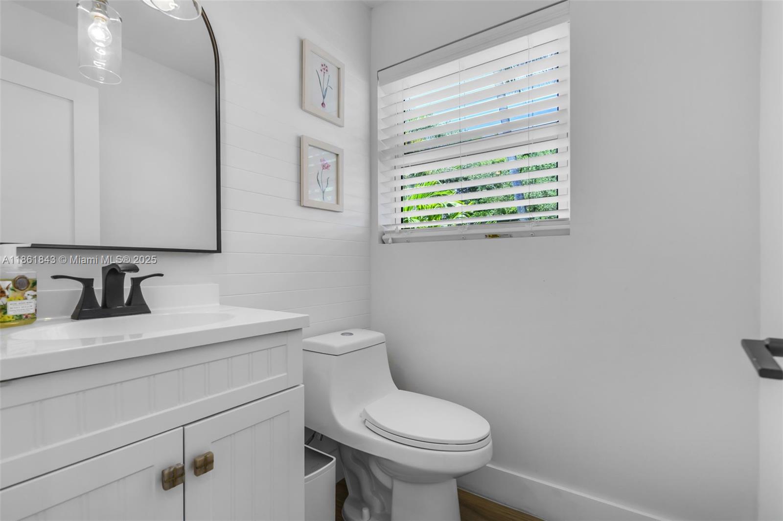 653 Glenridge Road Key Biscayne, FL 33149 - Photo 35 of 47 a bathroom with a granite countertop toilet sink and mirror