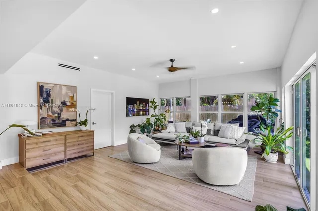 a living room with furniture and a potted plant