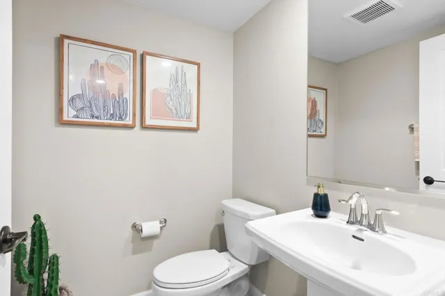 a bathroom with a toilet a sink and mirror