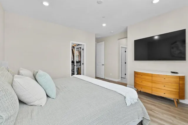 a bedroom with a bed and flat screen tv