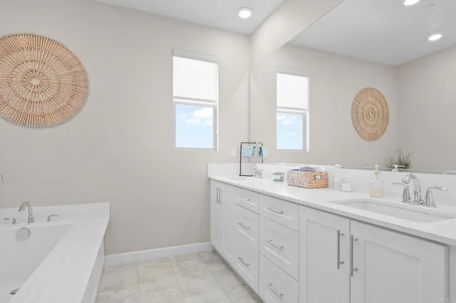 a bathroom with a double vanity sink and a mirror