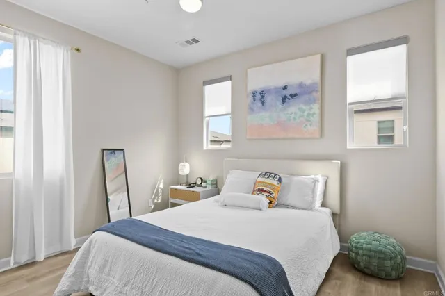 a bedroom with a bed and a window