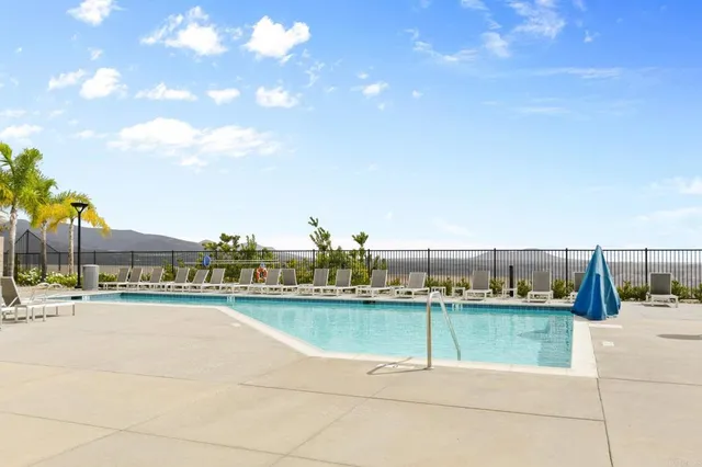 a view of a swimming pool with outdoor seating and plants