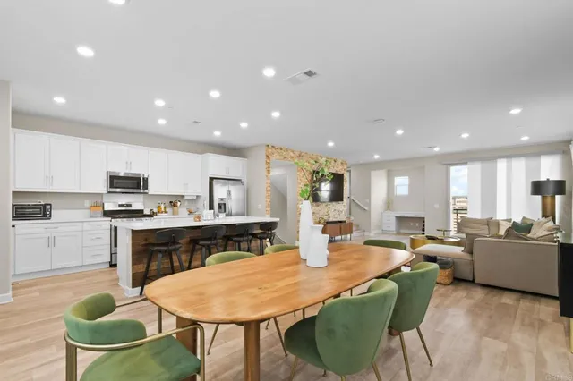 a large kitchen with a table and chairs