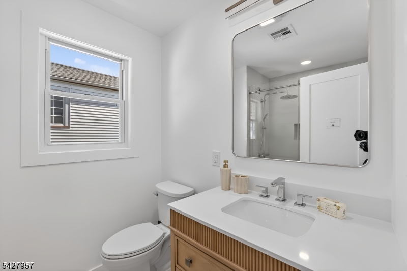 909 Ridgewood Road Millburn, NJ 07041 - Photo 18 of 33 a bathroom with a sink a toilet and mirror