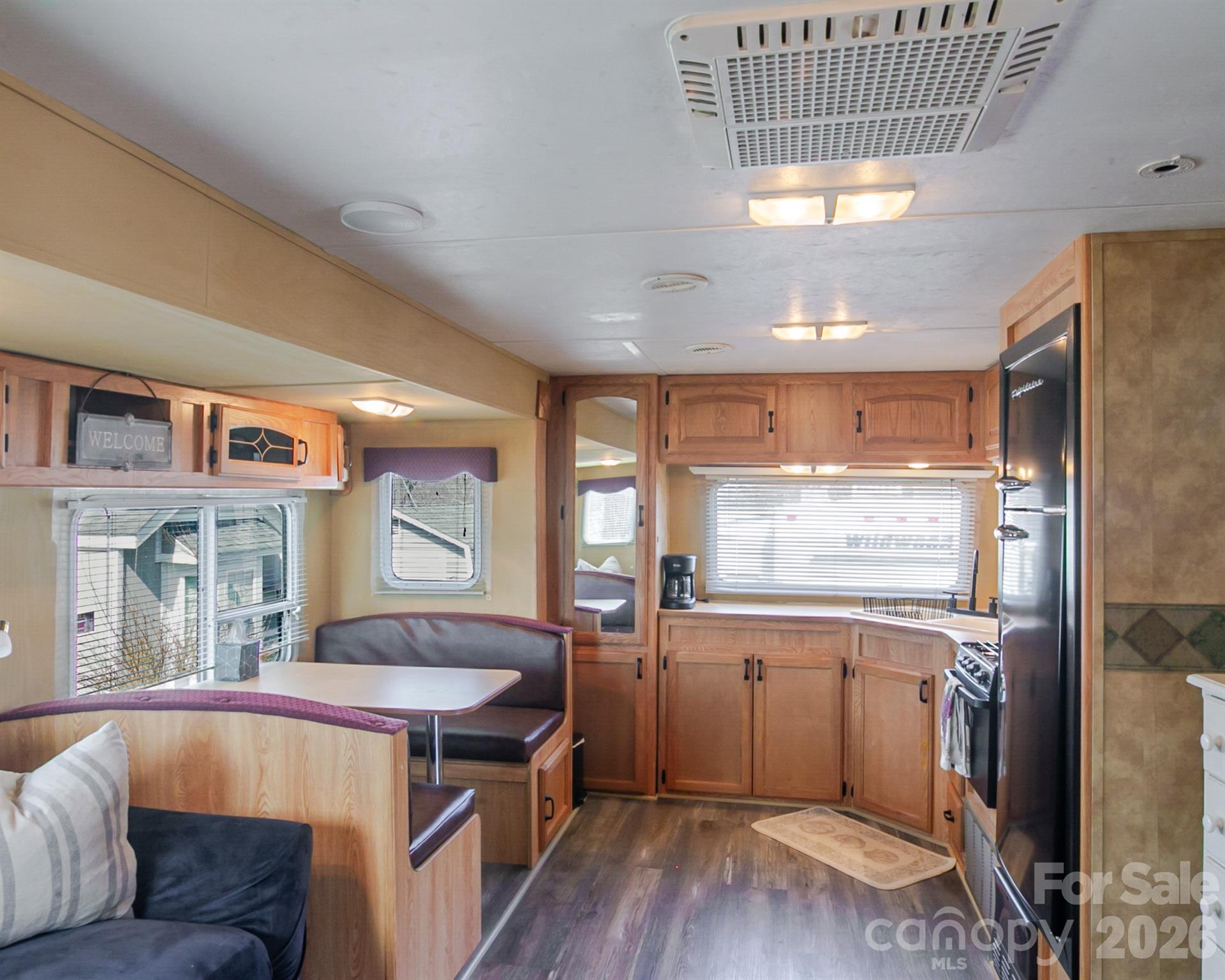 166 Badin Lake Road, Unit 757 New London, NC 28127 - Photo 15 of 45 a kitchen with a stove a refrigerator and wooden floor