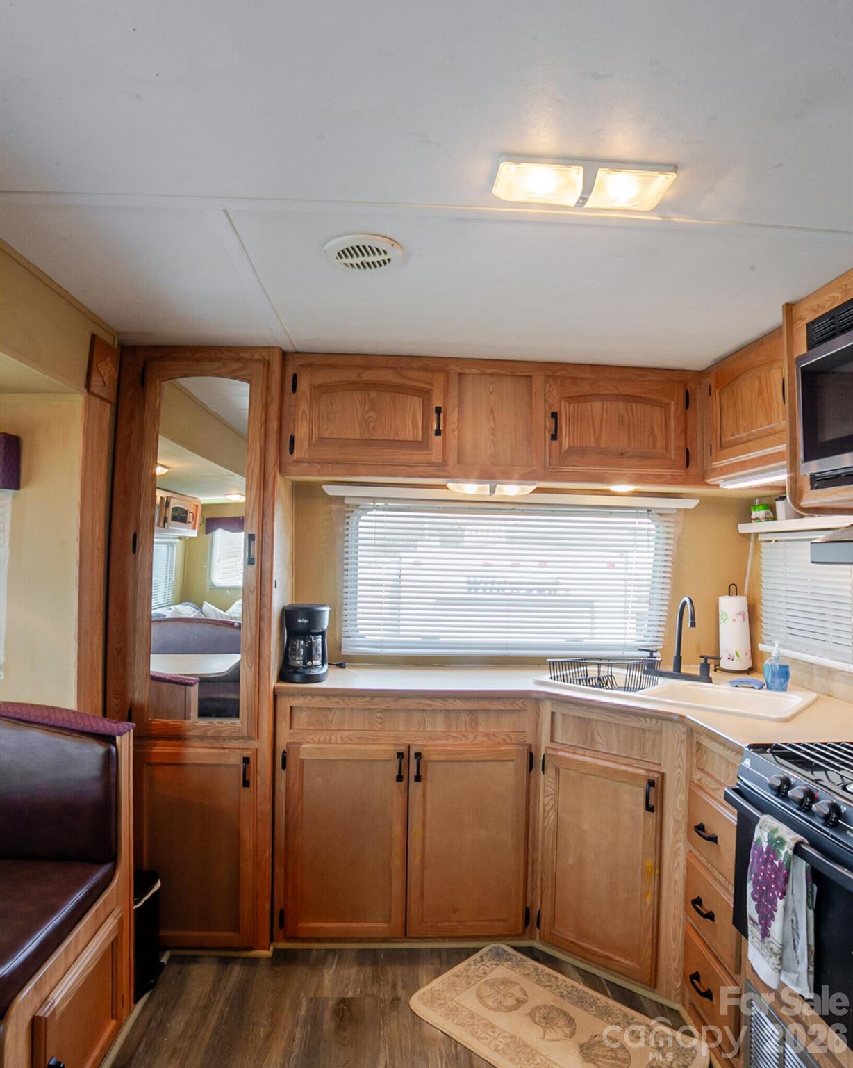166 Badin Lake Road, Unit 757 New London, NC 28127 - Photo 17 of 45 a kitchen with stainless steel appliances granite countertop a sink and cabinets