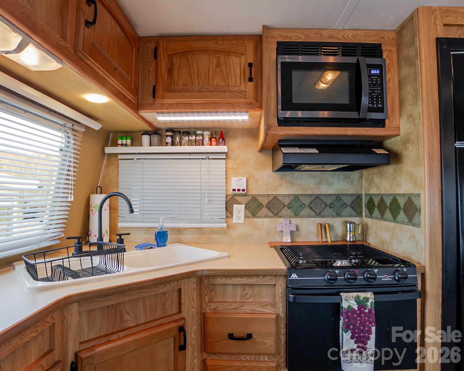 166 Badin Lake Road, Unit 757 New London, NC 28127 - Photo 18 of 45 a kitchen with a stove and a microwave