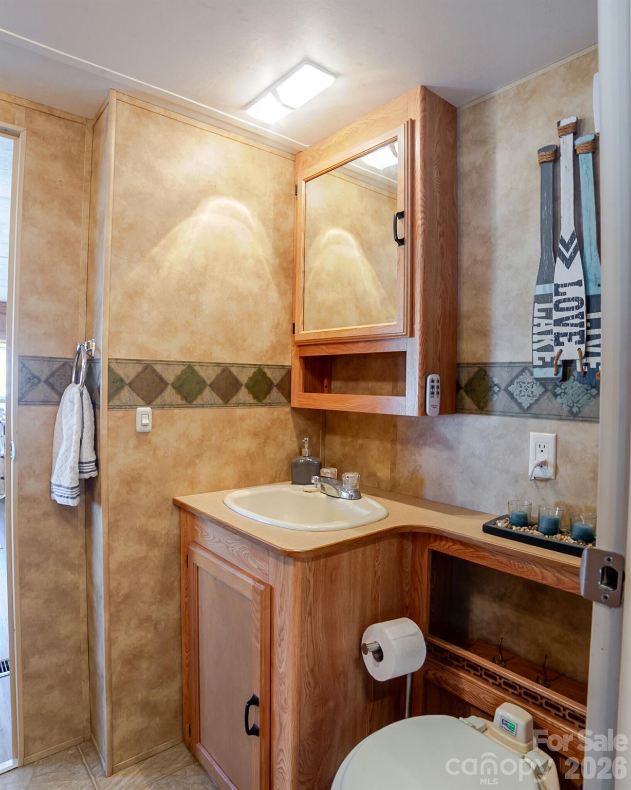 166 Badin Lake Road, Unit 757 New London, NC 28127 - Photo 21 of 45 a bathroom with a sink and a mirror