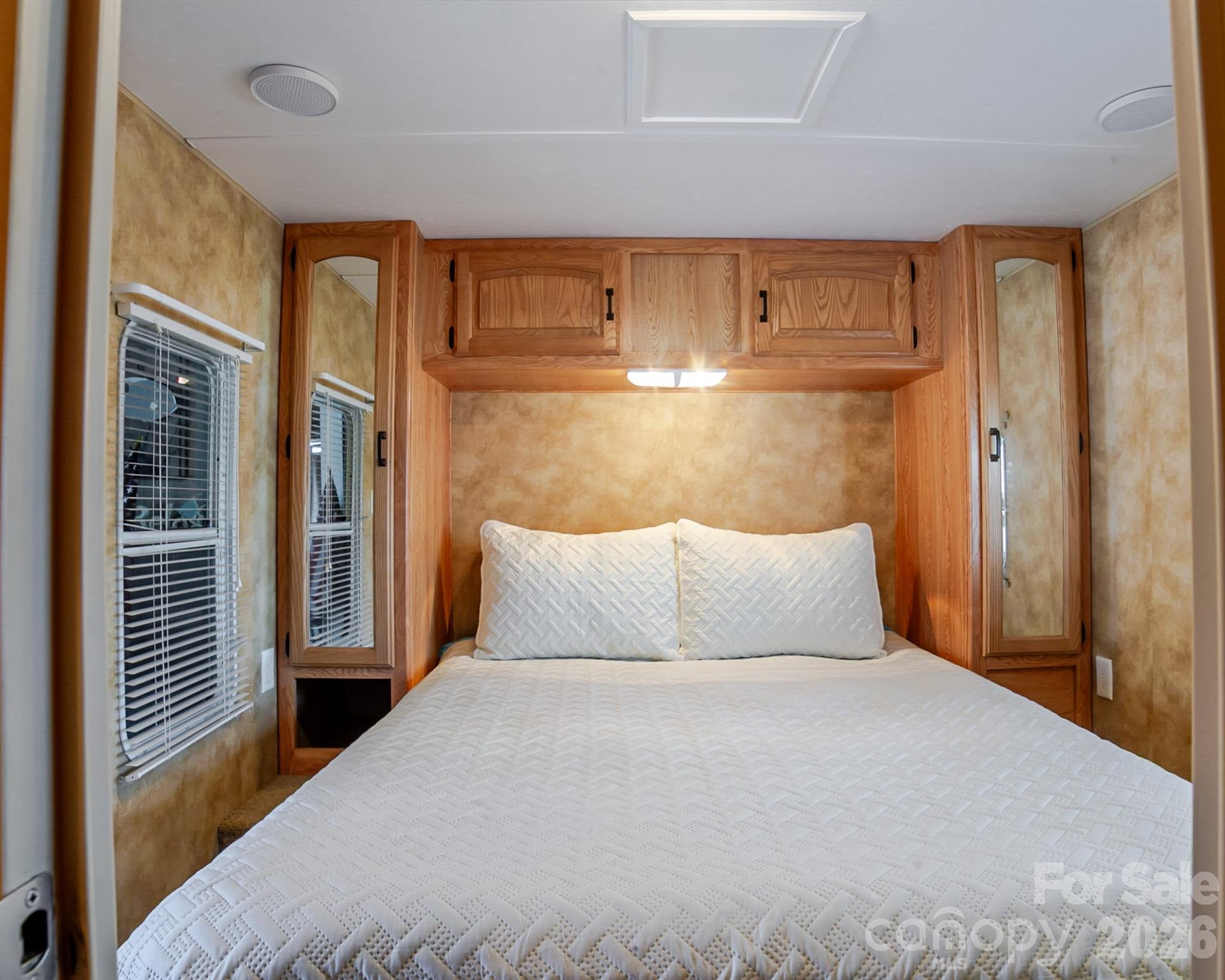 166 Badin Lake Road, Unit 757 New London, NC 28127 - Photo 23 of 45 a bedroom with a large bed and wooden floor