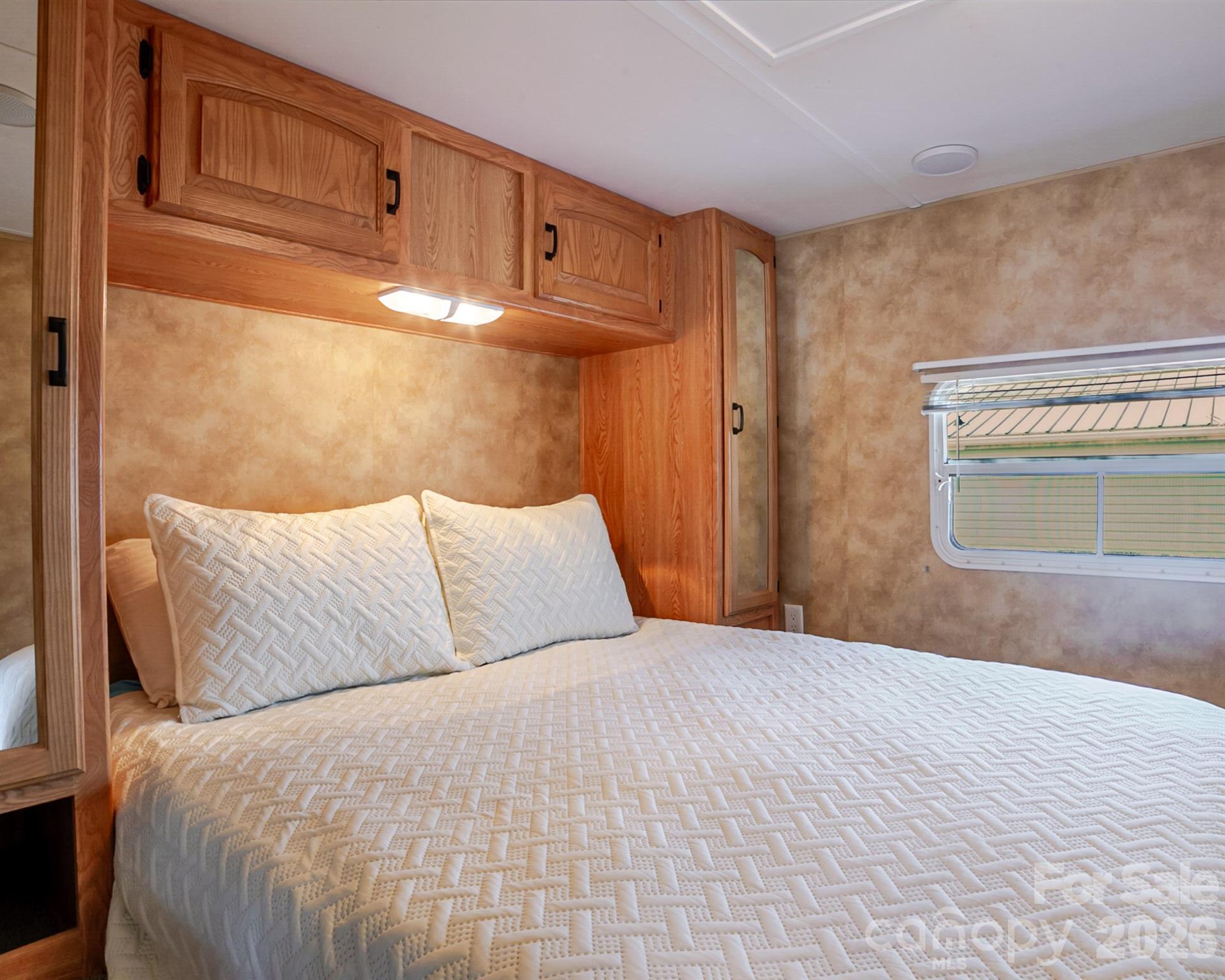 166 Badin Lake Road, Unit 757 New London, NC 28127 - Photo 25 of 45 a bedroom with a bed and a cabinets