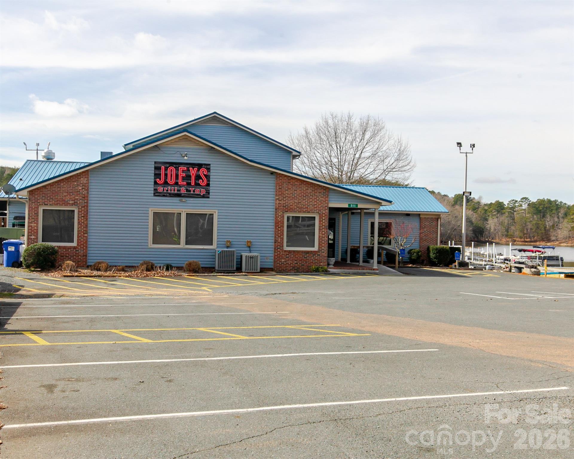 166 Badin Lake Road, Unit 757 New London, NC 28127 - Photo 33 of 45 a front view of a house with a yard and garage