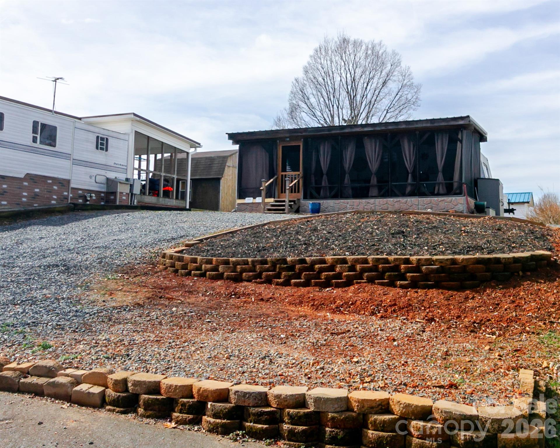 166 Badin Lake Road, Unit 757 New London, NC 28127 - Photo 7 of 45 a front view of a house with garden