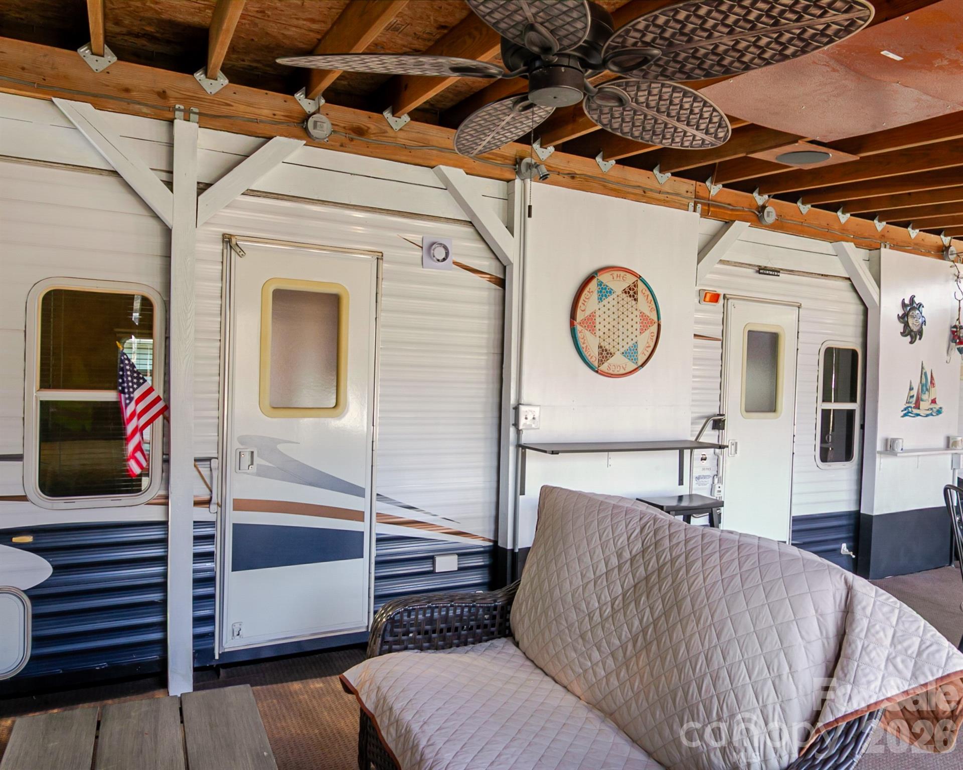 166 Badin Lake Road, Unit 757 New London, NC 28127 - Photo 9 of 45 a living room with a couch and a clock