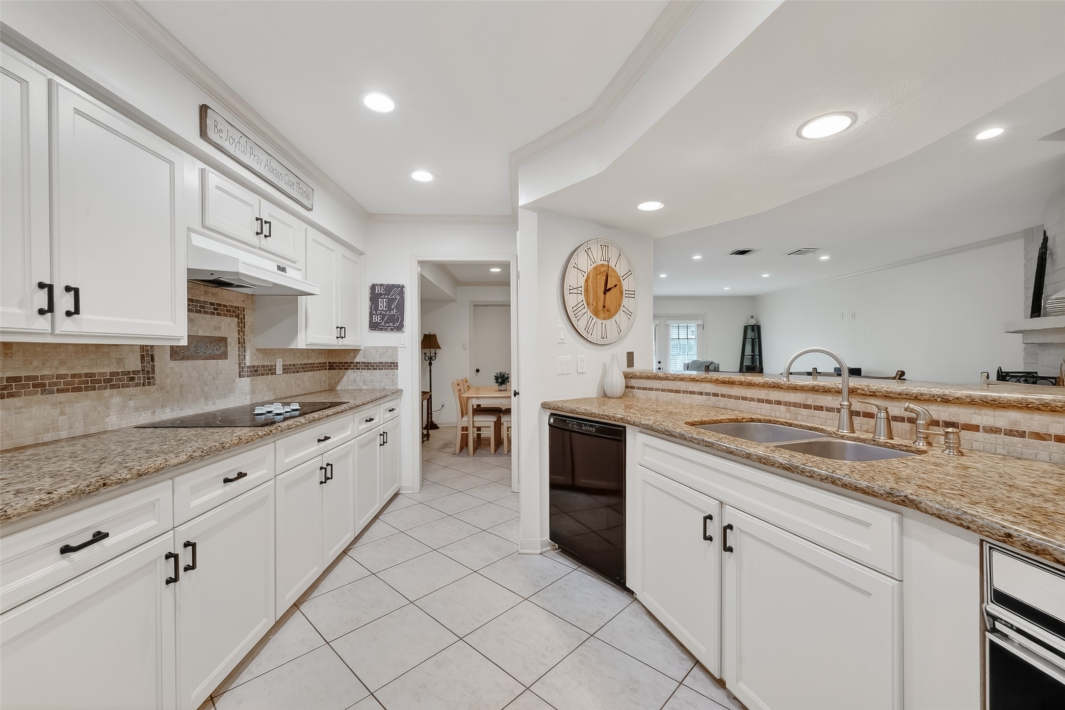 14690 Perthshire Road, Unit C Houston, TX 77079 - Photo 12 of 48 Reimagined with sleek granite and a lovely textured backsplash, this expansive kitchen features a long, raised counter that overlooks the main living area.